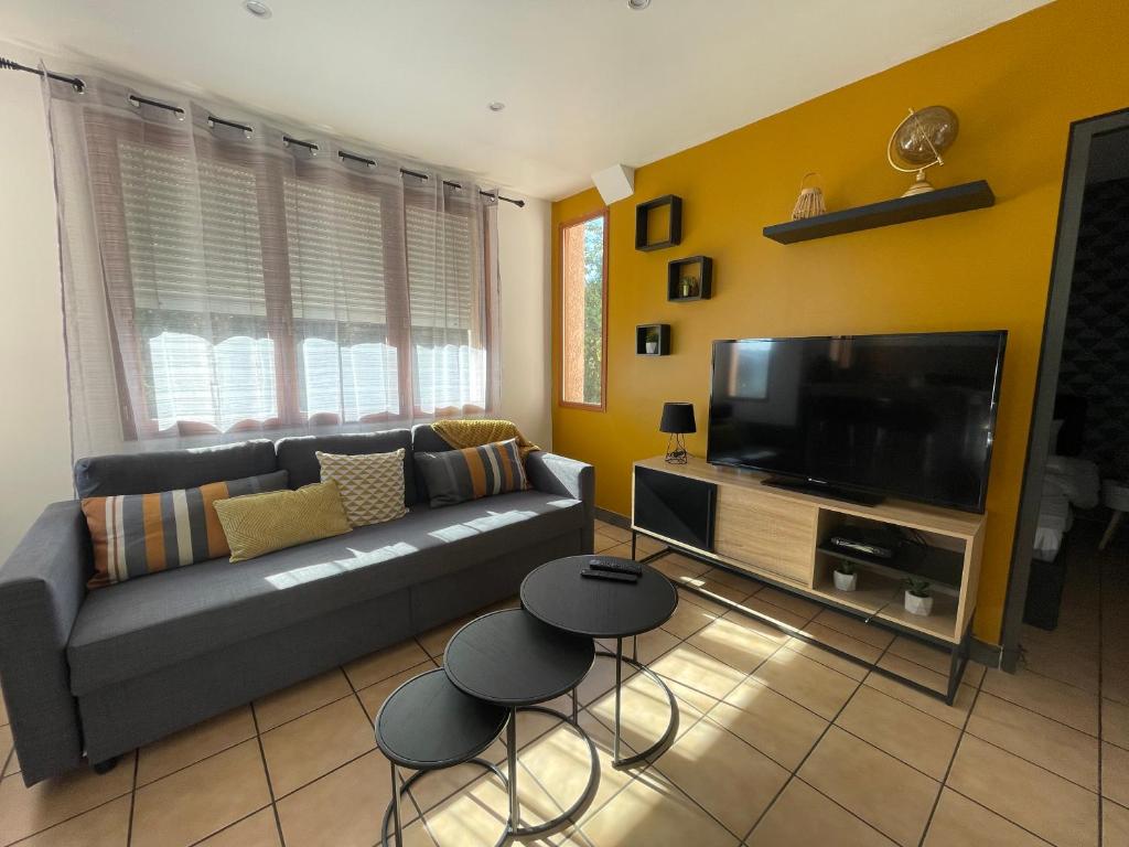 佩皮尼昂EXPLORE THE WORLD 3的带沙发和平面电视的客厅