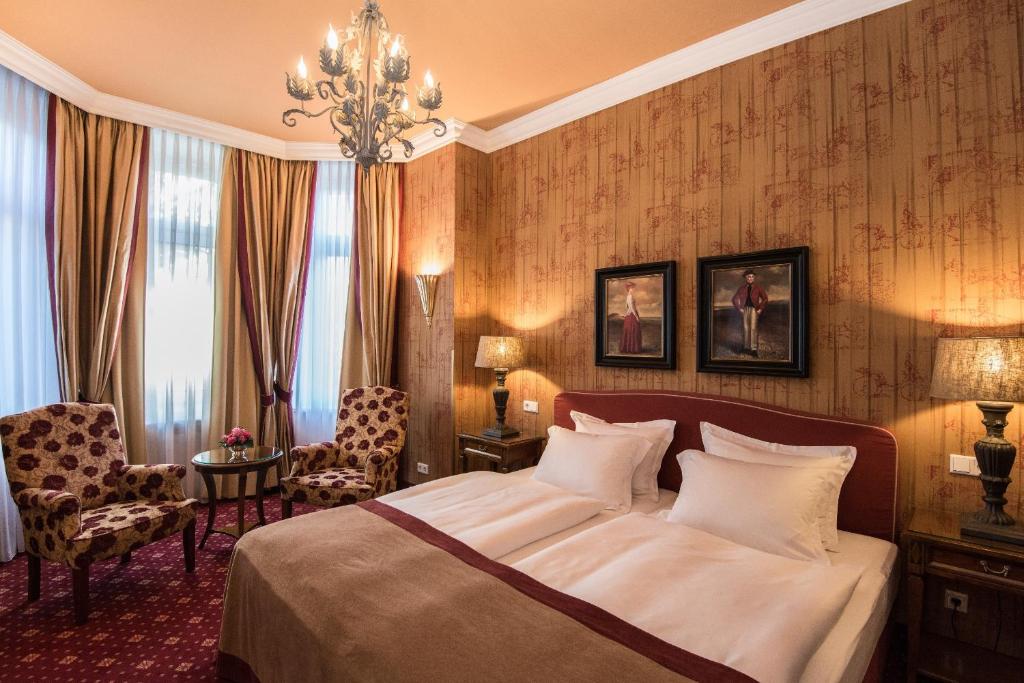 汉堡城市之家酒店的酒店客房,配有一张床和吊灯