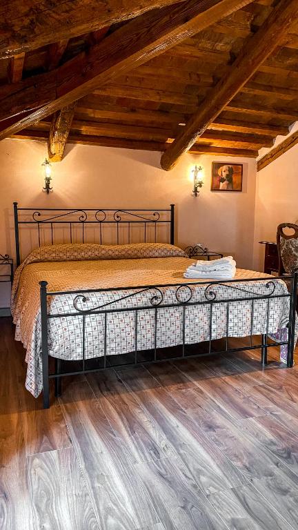 Ponte San NicoloLa busa camere e trattoria的铺有木地板的客房内一张大床