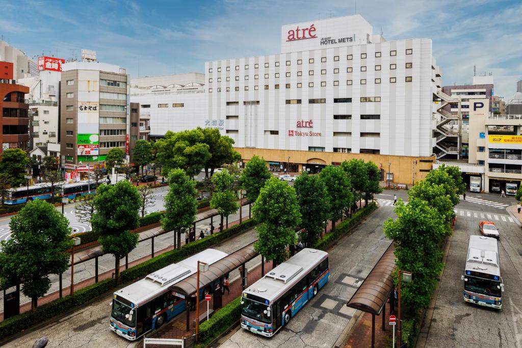 东京JR-East Hotel Mets Omori的停在城市的一群公共汽车