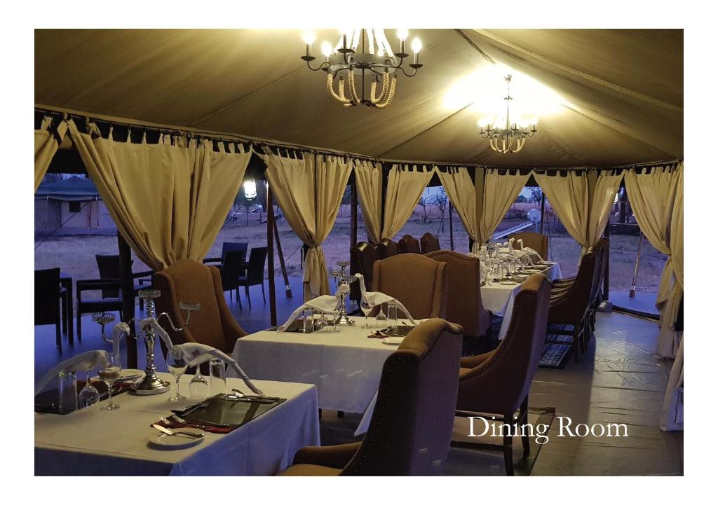 NyanunguOLE SERAI LUXURY CAMP - KOGATENDE的帐篷内带桌椅的用餐室