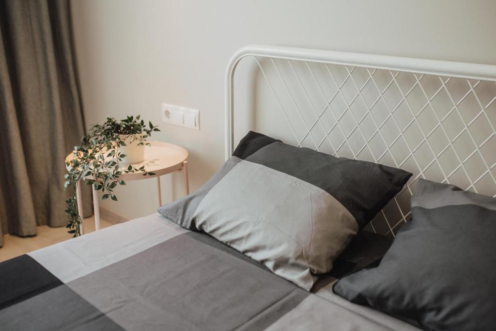 BrocēniRozenstein design residence的一间卧室配有一张带银色床头板的床