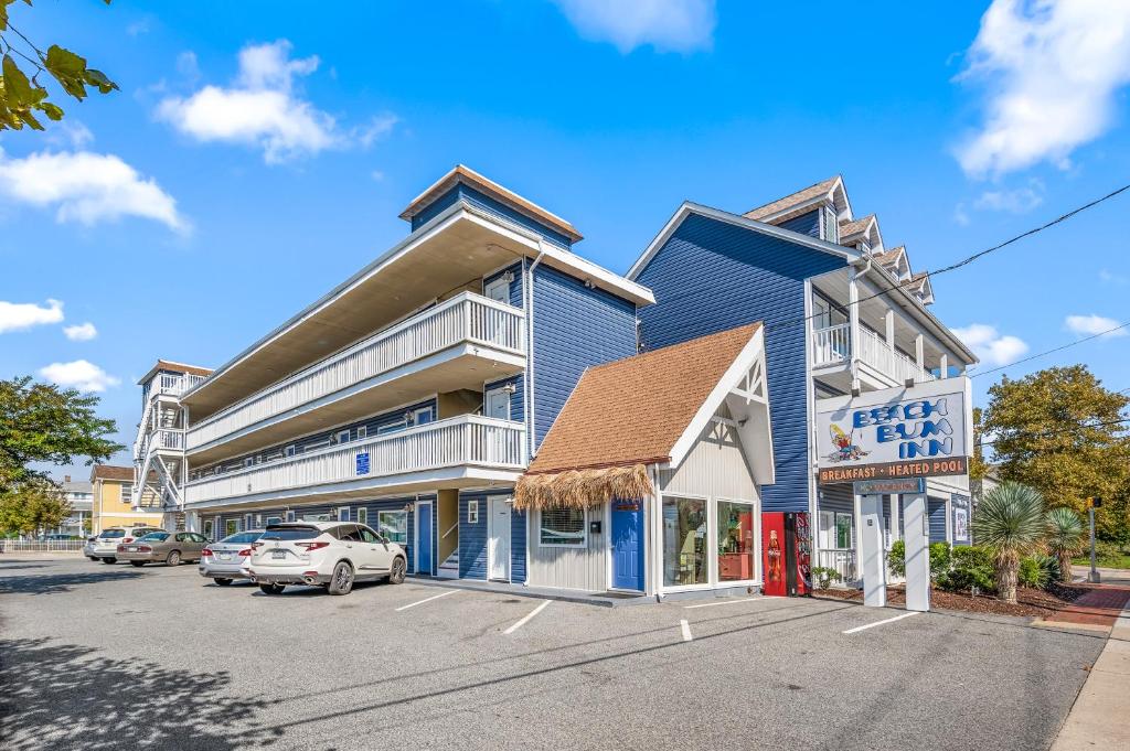 大洋城Beach Bum Inn的蓝色的建筑,有汽车停在停车场
