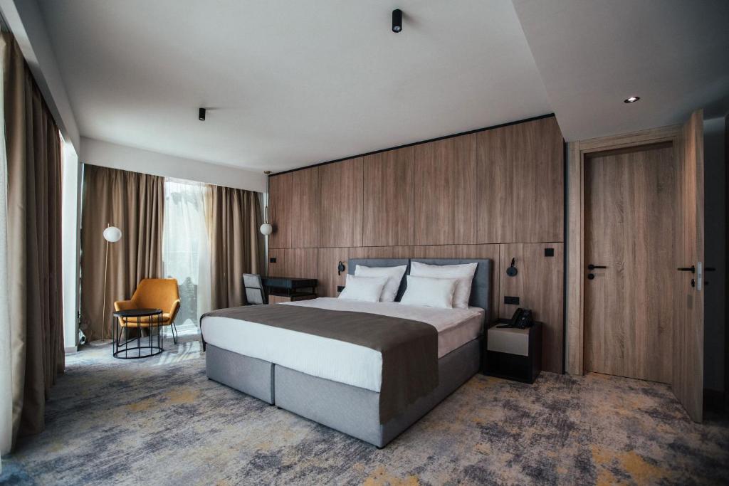 杜布罗夫尼克City Hotel Dubrovnik的一间卧室配有一张大床和一张书桌