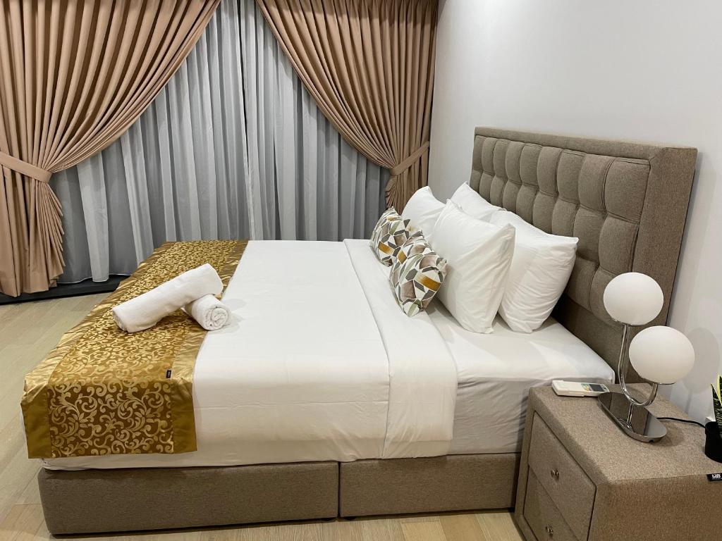 吉隆坡Eaton Residences KLCC by Luna的卧室配有一张带白色床单和枕头的大床。
