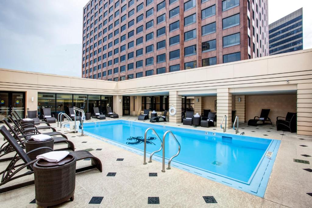 新奥尔良新奥尔良洲际酒店的一座带椅子的大型游泳池和一座建筑