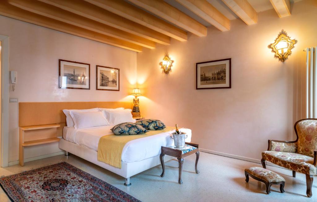 威尼斯圣卢卡宫住宿加早餐旅馆的一间卧室配有一张床、一把椅子和一张桌子