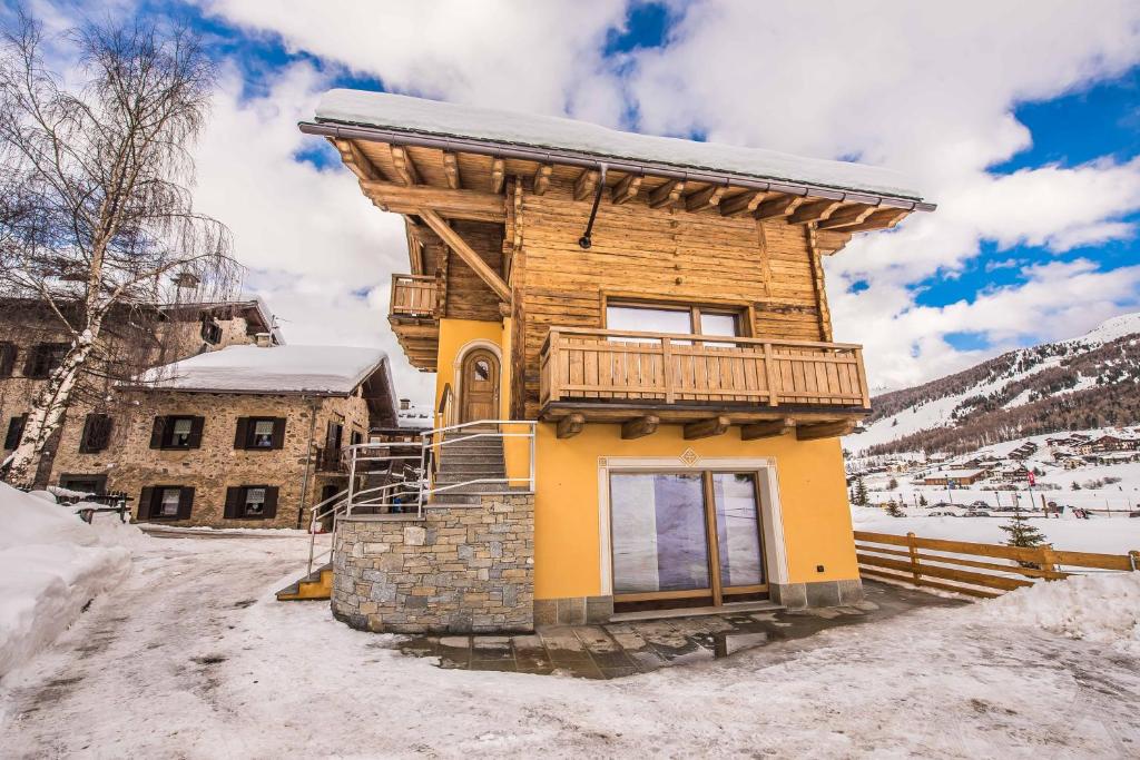 利维尼奥Chalet 4 Stagioni的木屋,在雪中设有阳台
