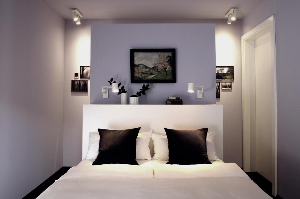 纽伦堡quartier26的卧室配有带黑色枕头的白色床