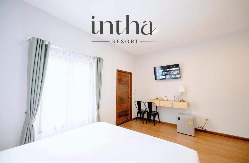 Ban Khao LaoIntha Resort的白色卧室配有床和书桌