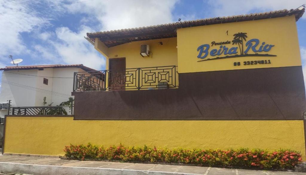 巴纳伊巴贝拉里约巴纳伊巴公寓的黄色的建筑,旁边标有标志