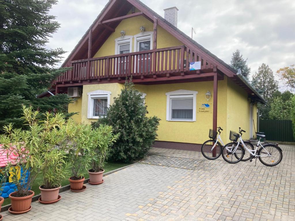 蒂萨凯奇凯Príma Vendégház的两辆自行车停在黄色房子前面