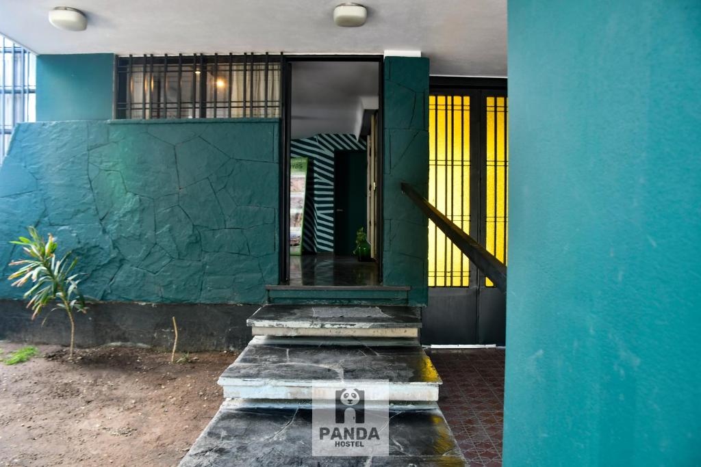 门多萨Panda Hostel Mendoza的一座带蓝色墙壁的房子的前门