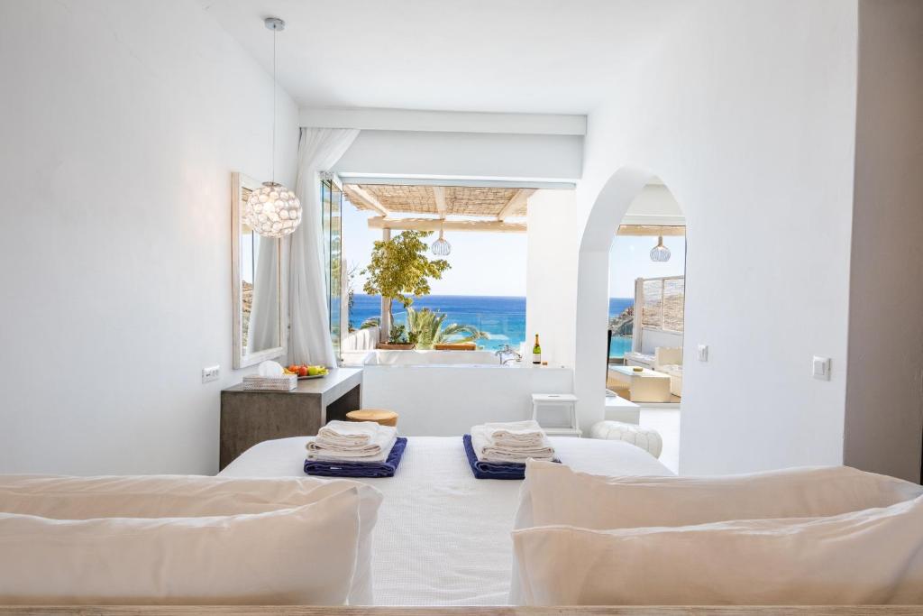 奇波斯阿费提Poseidon Blue Gastronomy Hotel的白色的客房配有两张床,享有海景。