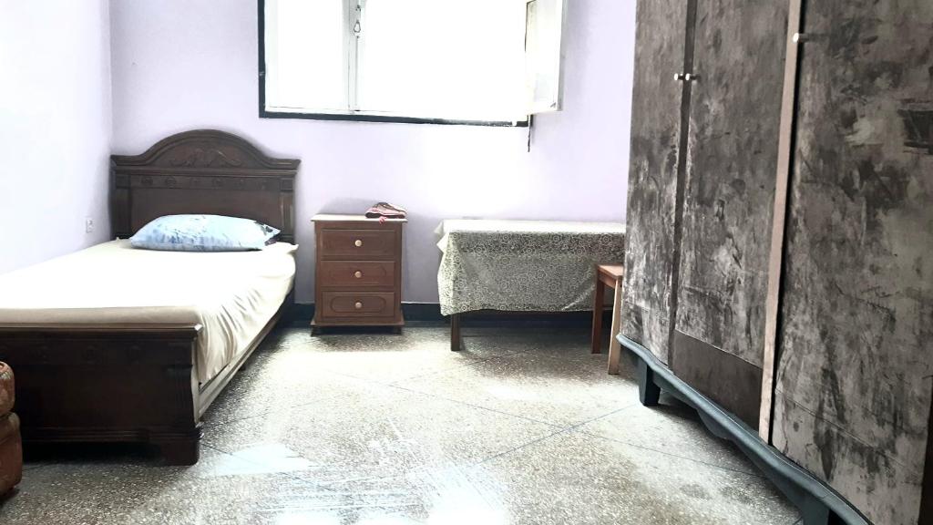 卡萨布兰卡Zitouna Rooms的一间卧室配有一张床、一个梳妆台和一扇窗户。