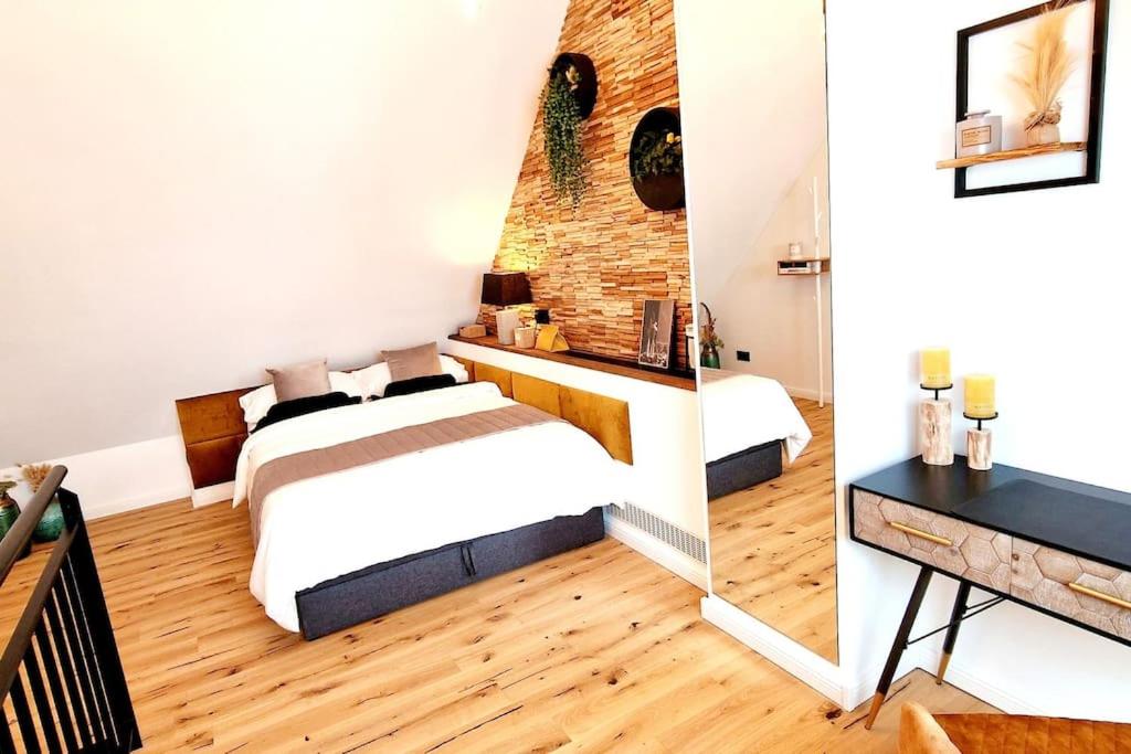 卡尔斯鲁厄Stilvolle Maisonette Wohnung的一间卧室设有两张床和砖墙