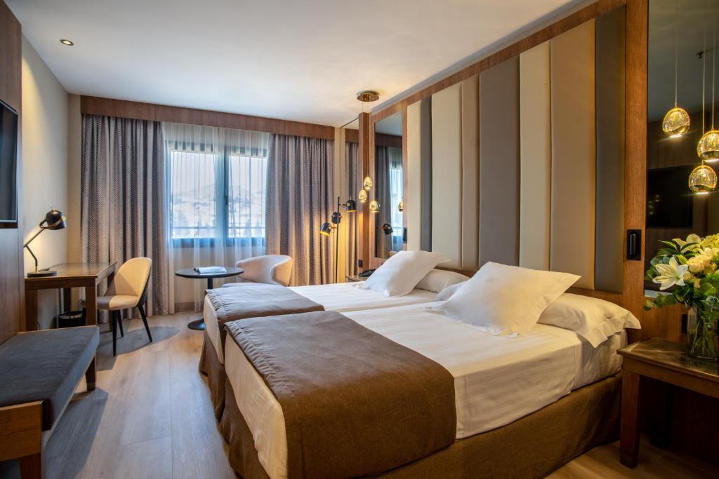 格拉纳达格拉纳达中心酒店的酒店客房设有一张大床和一张书桌。