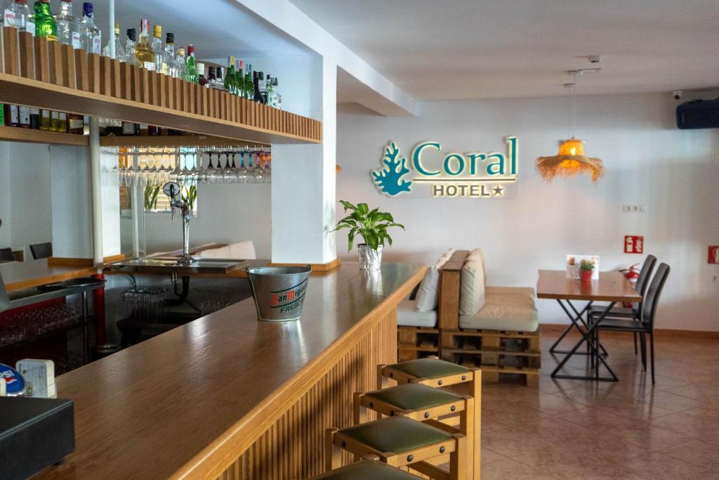 帕尔马海滩Coral beach house & food的餐厅的酒吧,墙上挂着酒店标志
