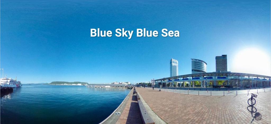 高松Aoi sora Aoi umi no guest house - Vacation STAY 86804v的蓝天蓝色的大海,设有码头和建筑