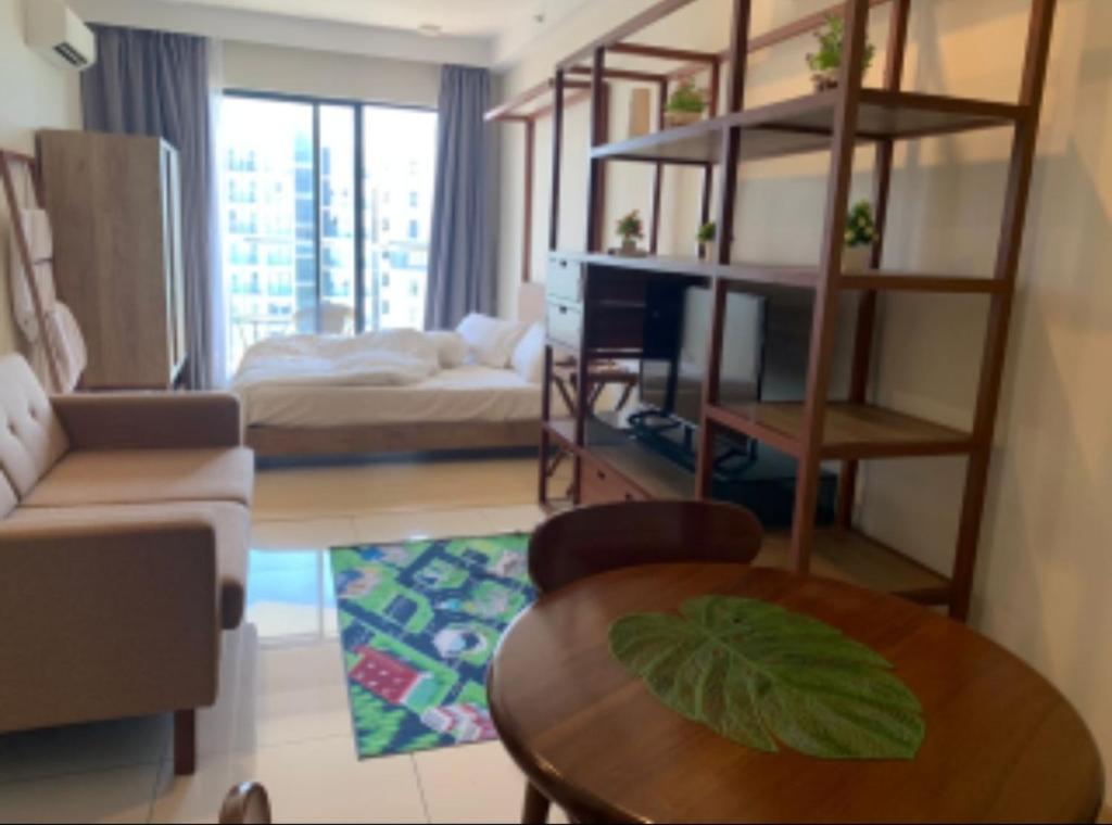 关丹PUTEH Timurbay Beachfront Private Suite Kuantan的客厅配有沙发和桌子。