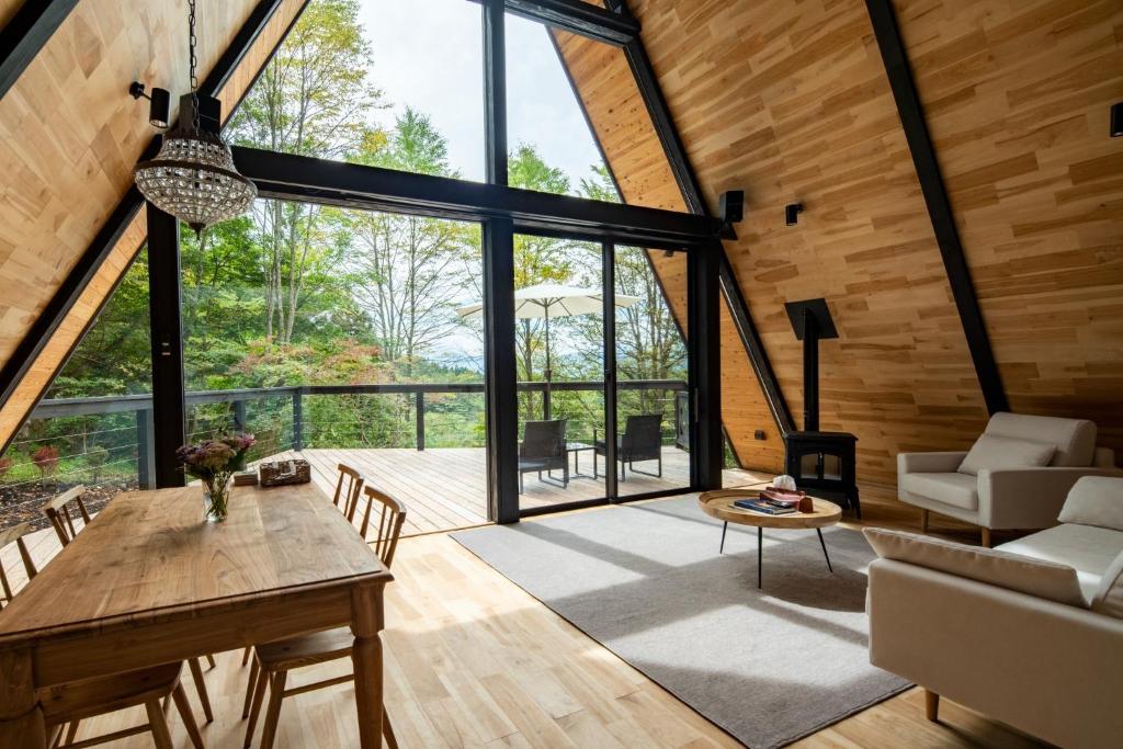 轻井泽A-Frame House Minami Karuizawa - Vacation STAY 58046v的开放式客厅配有桌子和沙发