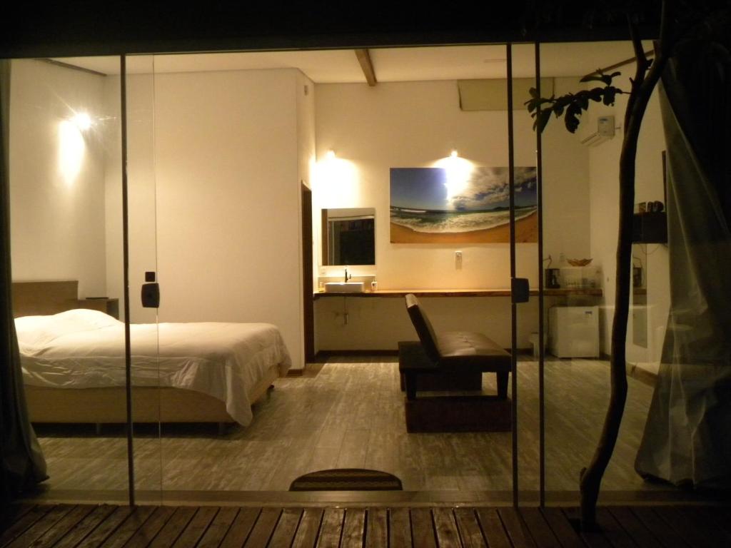弗洛里亚诺波利斯Green Lodge Eco Life Hotel的配有一张床和一把椅子的酒店客房