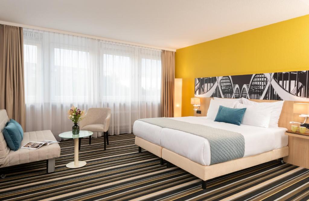 汉堡汉堡俄罗尔布克肯莱昂纳多酒店的配有一张床和一把椅子的酒店客房