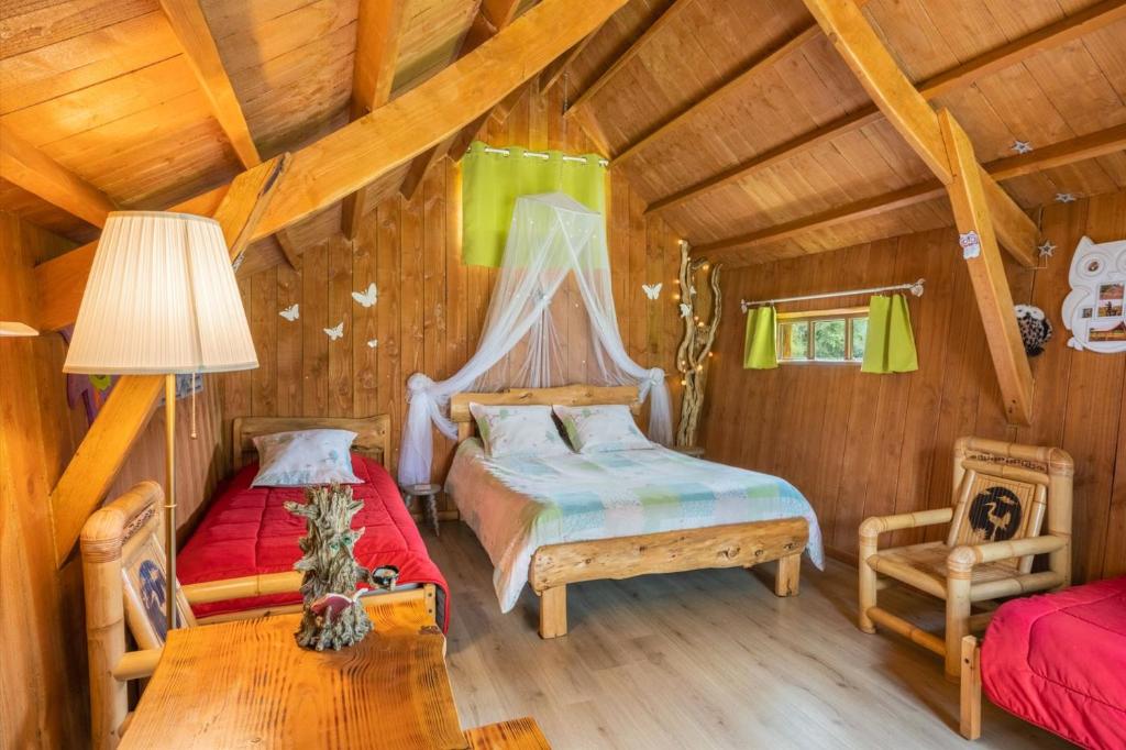 Plessé匹亚迪尔农家乐的小木屋内一间卧室,配有两张床