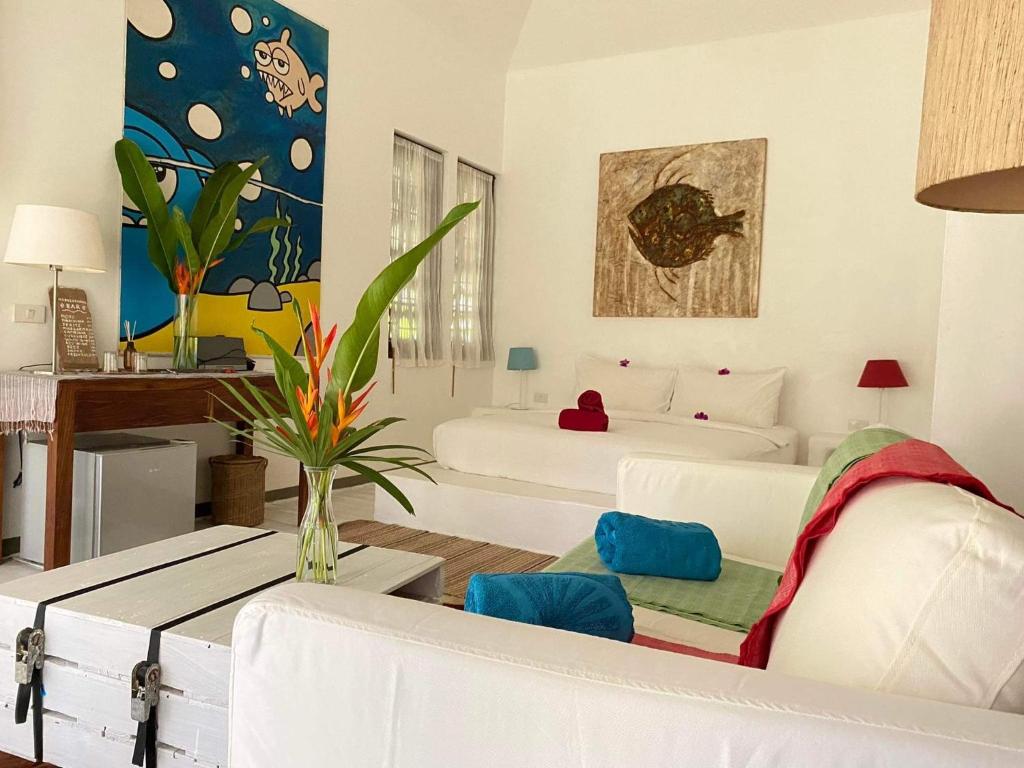 象岛Maddekehaoo Eco Mansion的一间带两张床和一张沙发的客厅