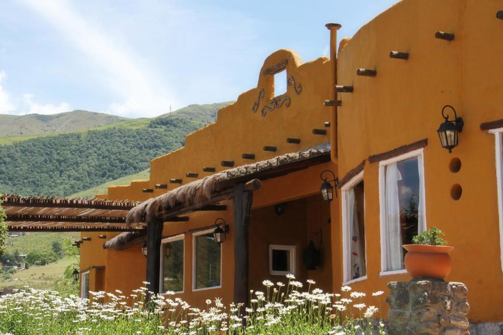 塔菲德尔瓦勒波萨达拉瓜达卢佩酒店的山中一座有鲜花的建筑