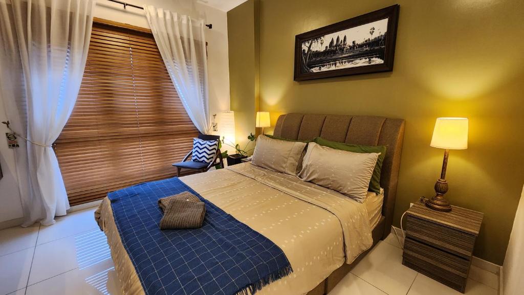 莎阿南Aldridge Residence Tropical Suite - EMIRA的一间卧室配有一张带蓝色毯子的床