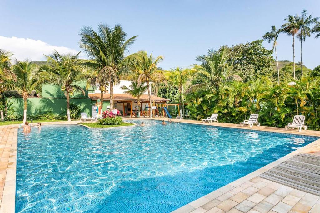 朱奎Juquehy - Casa Espaçosa em Condomínio的棕榈树度假村的游泳池