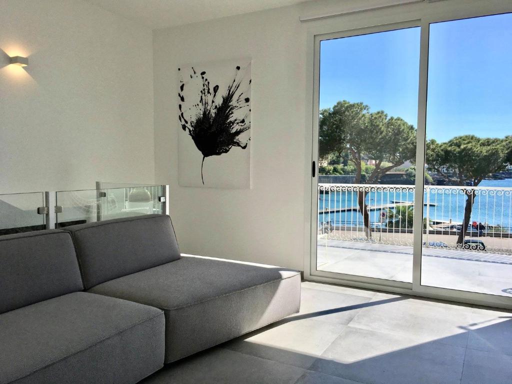 卡塔尼亚Sunshine Luxury Apartment - Ognina Catania的带沙发和大窗户的客厅