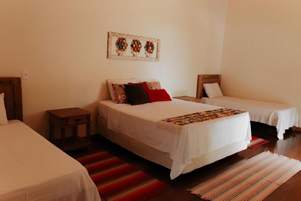 Hotel Pousada Chalé das Flores客房内的一张或多张床位