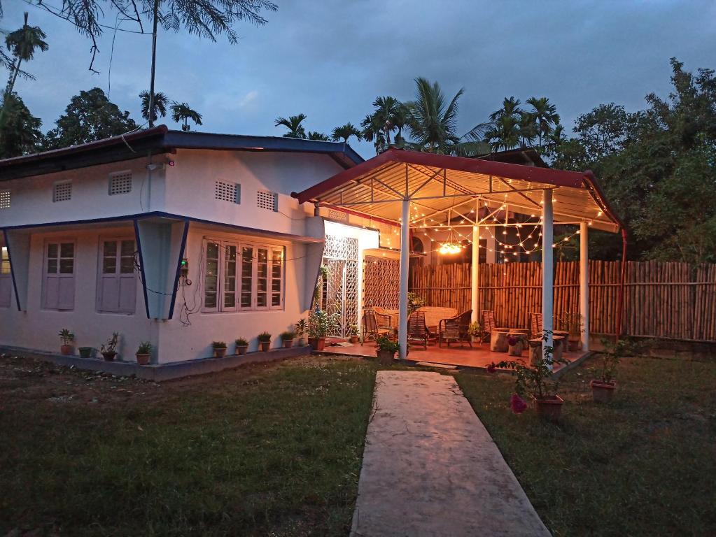 焦尔哈德Assam Villa - by Storyweavers Retreat的院子里有凉棚的房子