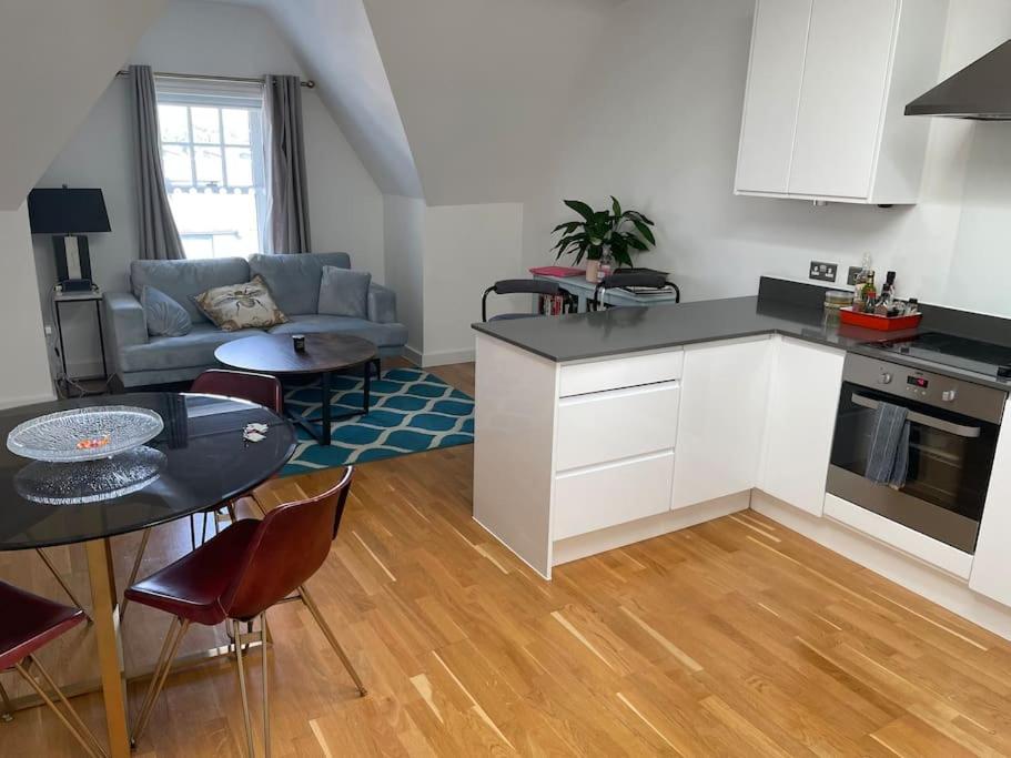 伊灵Lovely 2-bed flat with well equipped kitchen的厨房以及带桌子和沙发的客厅。