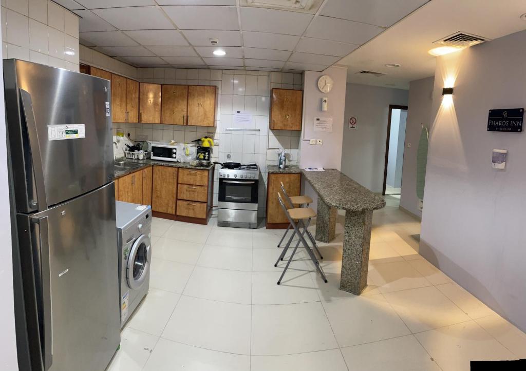 迪拜Pharos Inn Sheikh Zaied Private bed space的厨房配有不锈钢冰箱和台面