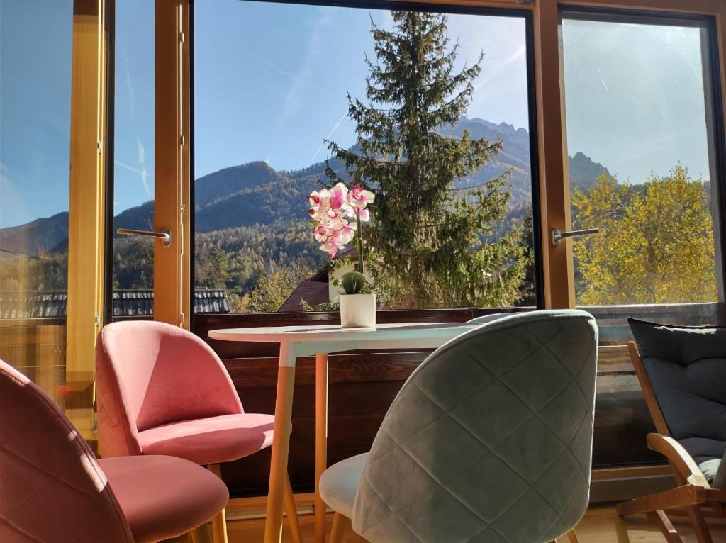克拉尼斯卡戈拉Appartement Bella Vista的客房设有桌椅和大窗户。