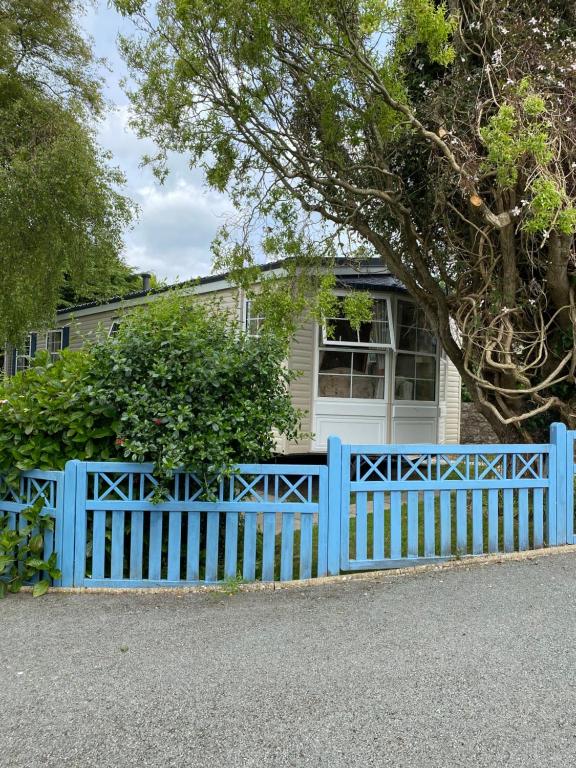 莫伊尔弗雷“Ty Hir Caravan” Moelfre的房屋前的蓝色围栏