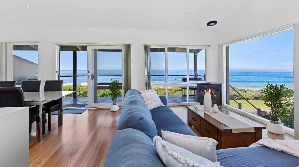阿波罗湾Whitecrest Eco Apartments Great Ocean Road的客厅配有蓝色沙发,享有海景