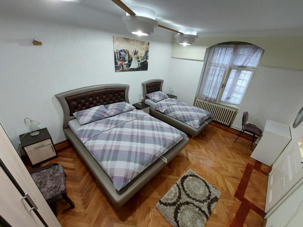 贝尔格莱德布科利昂公寓的一间卧室设有两张床和窗户。