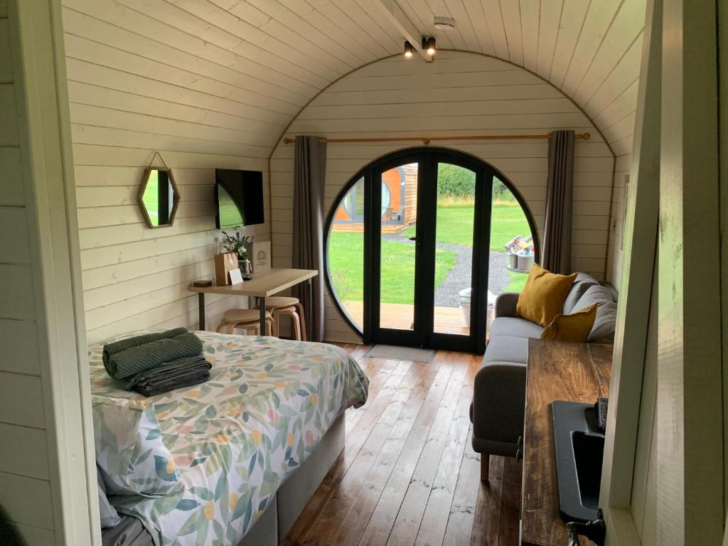 马克Laurel Farm Glamping的一间卧室设有一张床和一个拱形门廊