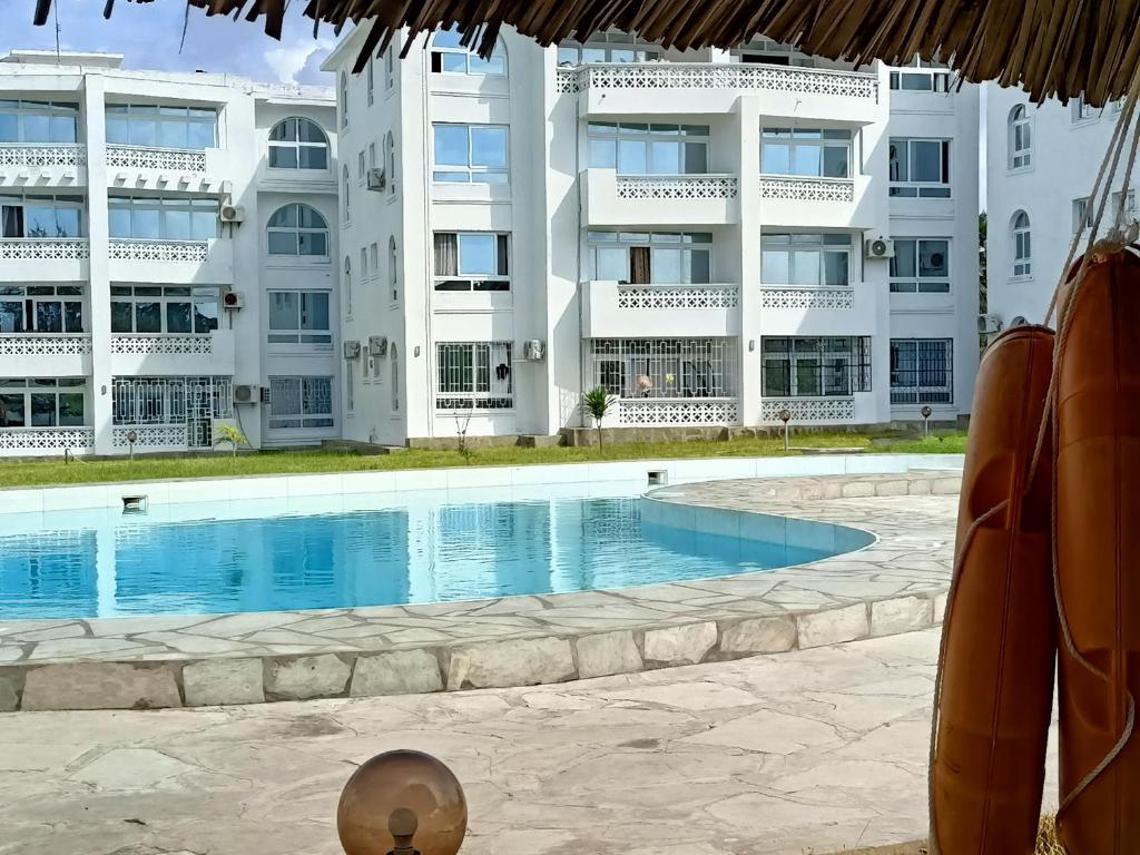 马林迪PahaliMzuri Kijani - 1 Bedroom Beach Apartment with Swimming Pool的一座大建筑前的游泳池