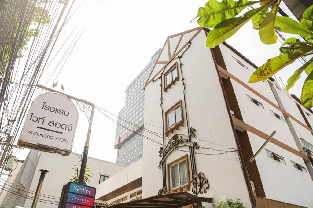 曼谷White Lodge Hotel Bangkok的建筑的侧面有标志