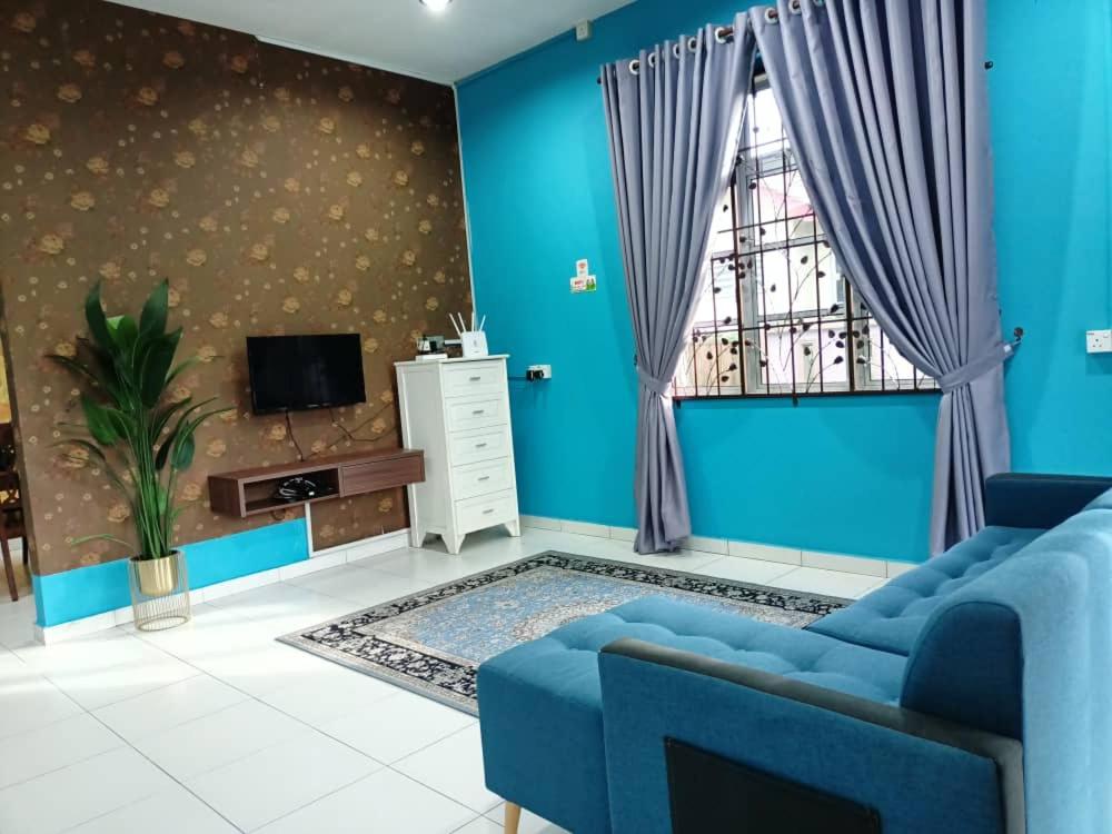 甘榜甘马挽Homestay Kemaman Private Pool Fyna的蓝色的客厅设有蓝色的沙发和窗户