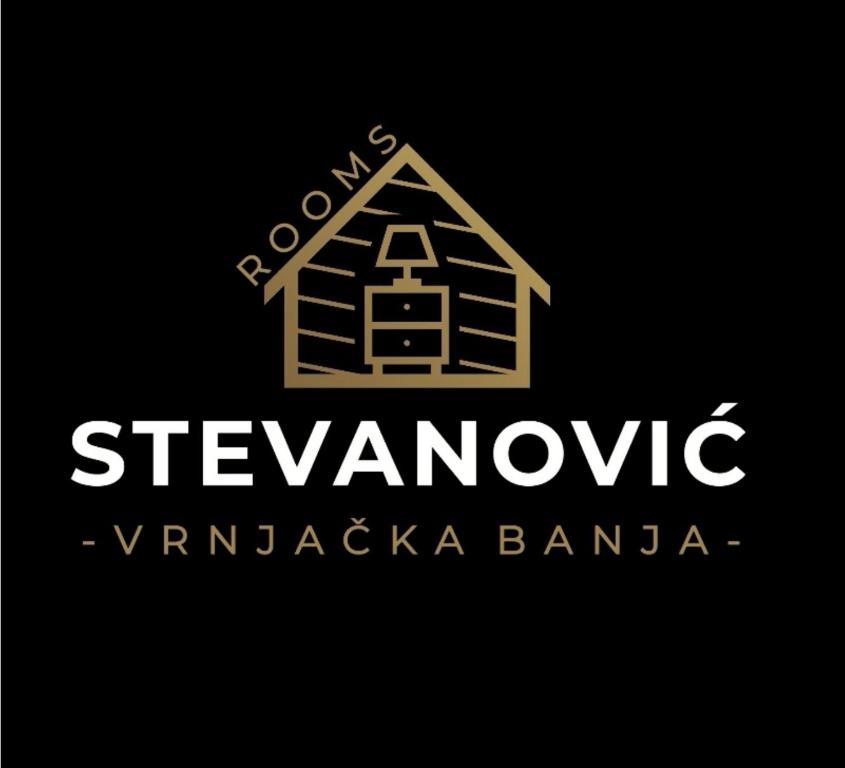VrnjciStevanovic Smestaj的黑底木房子的标志
