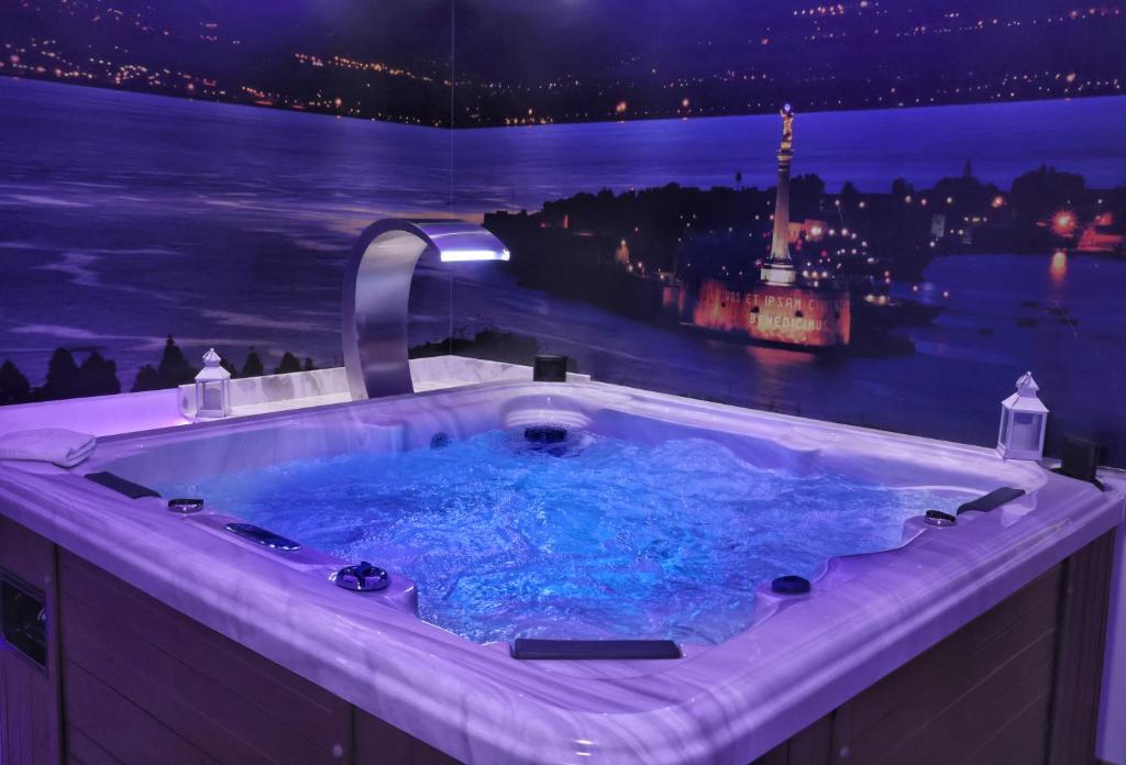 墨西拿Messina41 Hotel的按摩浴缸,晚上可欣赏到城市美景