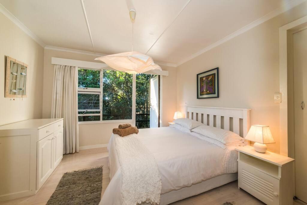 自然谷Kostaplenti的卧室配有白色的床和窗户。