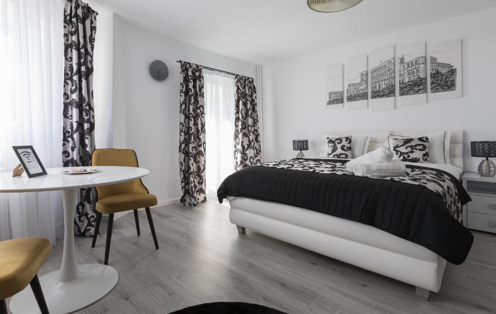 布加勒斯特Lion's Unirii Apartment的白色卧室配有床和桌子