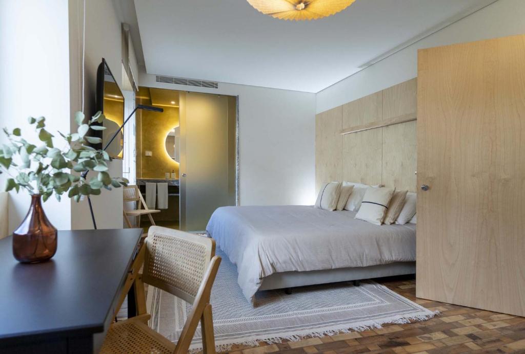 布朗库堡CASA 3 - OS LUGARES DE CASTRALEUCA的一间卧室配有一张床和一张花瓶桌子